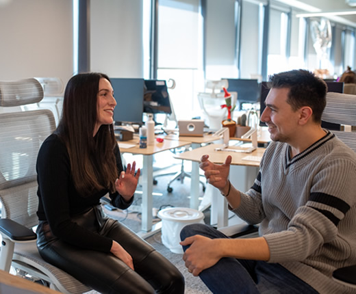 Image of two lumen employees working and looking at a computer